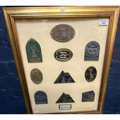 540 - A framed collection of canal boat or narrowboat brass and aluminium rally plaques. Framed and glazed... 