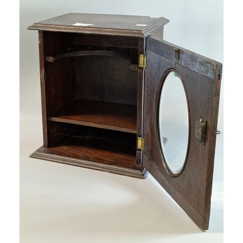 87 - Early 20th century oak smoker's cabinet with mirrored door, and key.  (B.P. 21% + VAT)