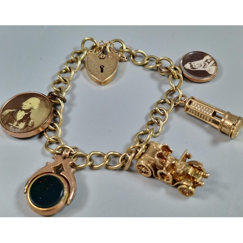 100 - 9ct gold curb-link charm bracelet to include: heart shaped padlock, vintage car, bloodstone revolvin... 