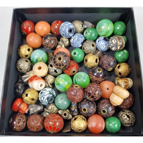 152 - Group of sixty two Japanese Ojime beads in a variety of materials: lacquered wood, hardstones, metal... 