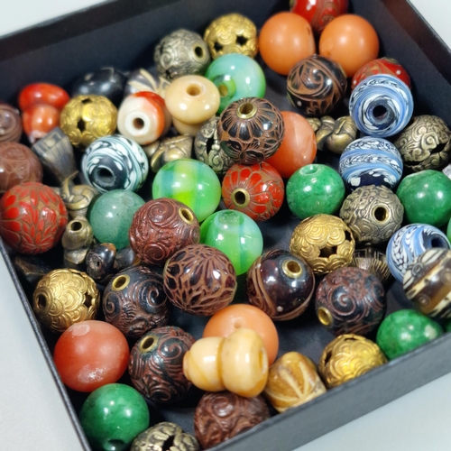 152 - Group of sixty two Japanese Ojime beads in a variety of materials: lacquered wood, hardstones, metal... 