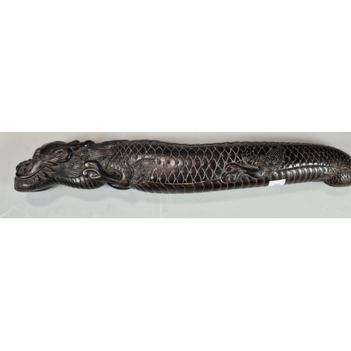 158 - Carved dark hardwood study of a three toed Dragon, intricately carved. Probably Japanese. 26cm long ... 