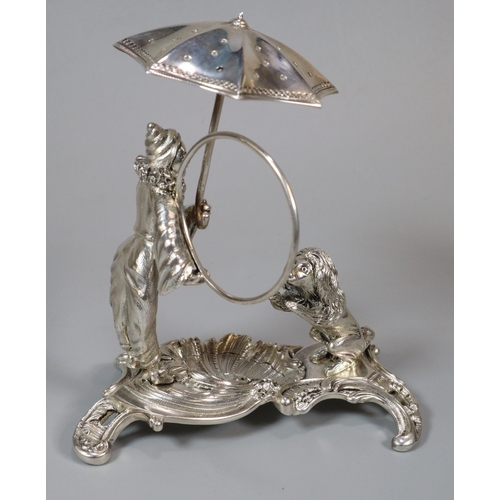 16 - Unusual white metal, probably continental circus figure group of a harlequin with umbrella and ring ... 