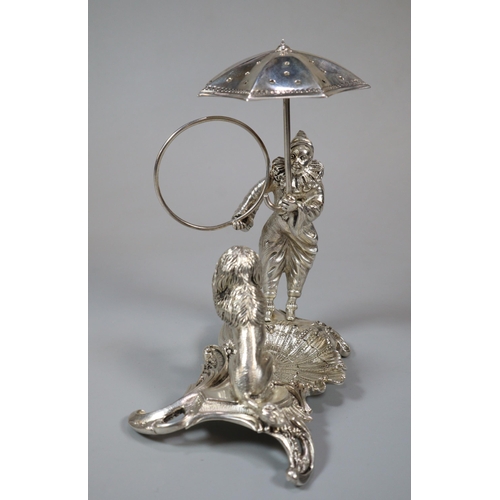 16 - Unusual white metal, probably continental circus figure group of a harlequin with umbrella and ring ... 