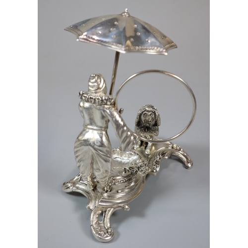 16 - Unusual white metal, probably continental circus figure group of a harlequin with umbrella and ring ... 