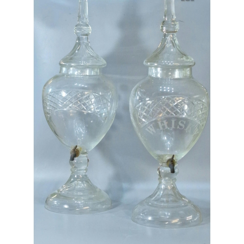 165A - Two similar Victorian cut glass urn shaped liquid/spirit dispensers with domed covers, one marked Wh... 