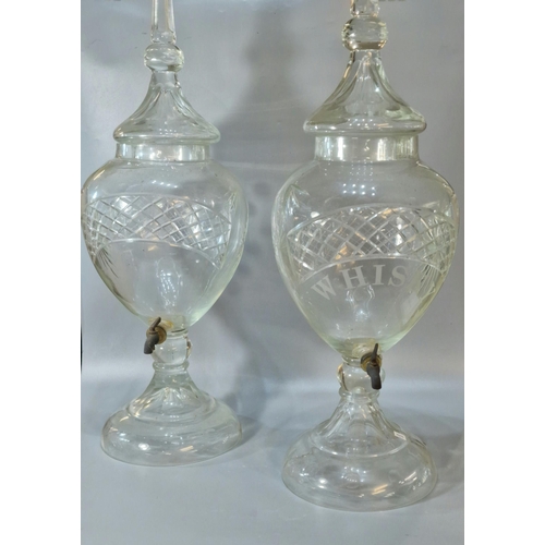 165A - Two similar Victorian cut glass urn shaped liquid/spirit dispensers with domed covers, one marked Wh... 