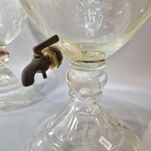 165A - Two similar Victorian cut glass urn shaped liquid/spirit dispensers with domed covers, one marked Wh... 