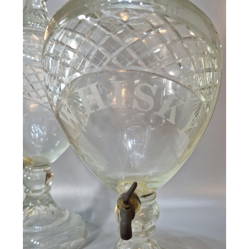 165A - Two similar Victorian cut glass urn shaped liquid/spirit dispensers with domed covers, one marked Wh... 