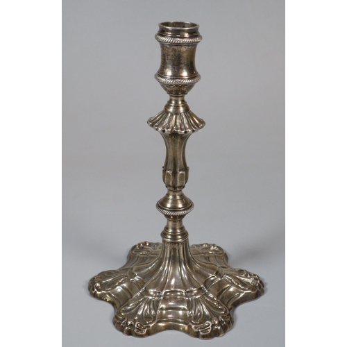 17 - George III silver taper stick with fluted and gadroon banded stem on a scroll work petal base. Londo... 