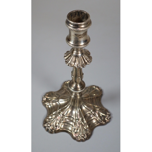 17 - George III silver taper stick with fluted and gadroon banded stem on a scroll work petal base. Londo... 