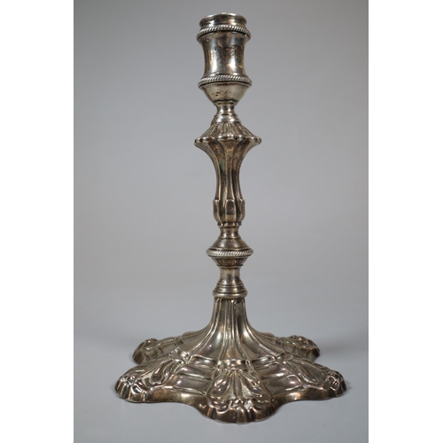 17 - George III silver taper stick with fluted and gadroon banded stem on a scroll work petal base. Londo... 