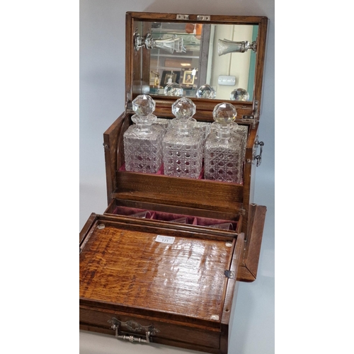 171 - Late Victorian oak three section tantalus and games compendium comprising three cut glass square sec... 