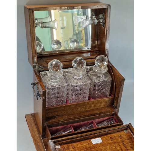 171 - Late Victorian oak three section tantalus and games compendium comprising three cut glass square sec... 