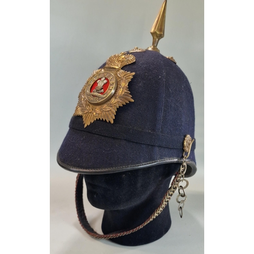 179 - British Victorian blue cloth helmet, with Welsh Regiment brass helmet plate and chin strap.  
Condit... 