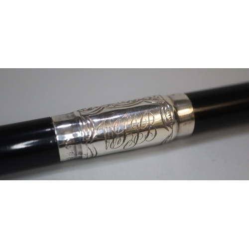 19 - George V silver embossed mounted and ebony two piece conductor's baton in original lined silk and ve... 