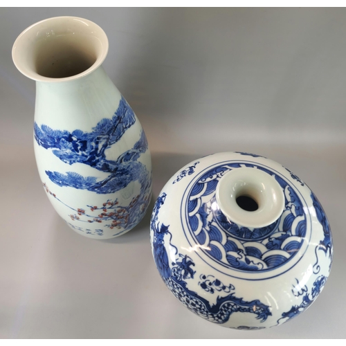 199 - Two Oriental porcelain blue and white vases to include one with copper red highlights in the motif a... 