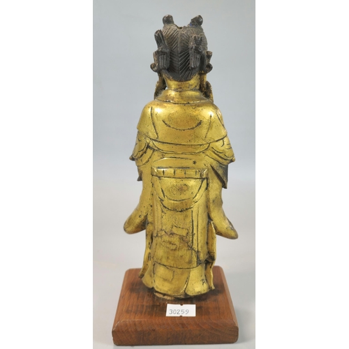 200 - Chinese Ming standing gilt bronze figure of Longnu, holding a sacrificial bowl containing a flaming ... 