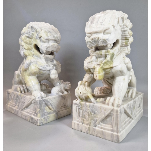 213 - Pair of Chinese carved soft stone Buddhist Temple Lions (Dogs of Foo), the male with his foot on a b... 