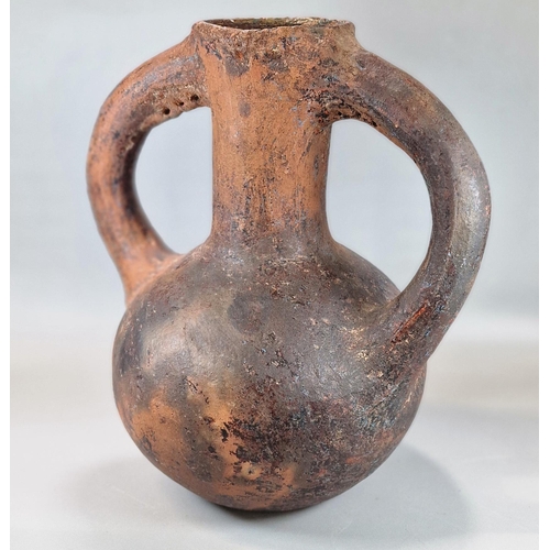 216 - Archaic terracotta two handled baluster shaped vase, seemingly of some antiquity.  33cm high approx.... 