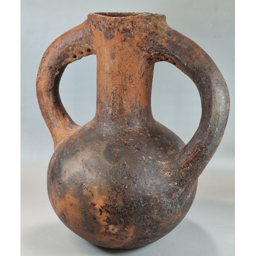 216 - Archaic terracotta two handled baluster shaped vase, seemingly of some antiquity.  33cm high approx.... 