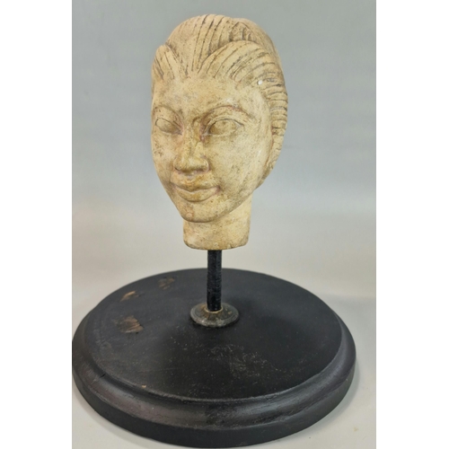 217 - Indonesian/Polynesian hardstone bust of a woman with eyes closed on later stand, the head 11.5cm hig... 