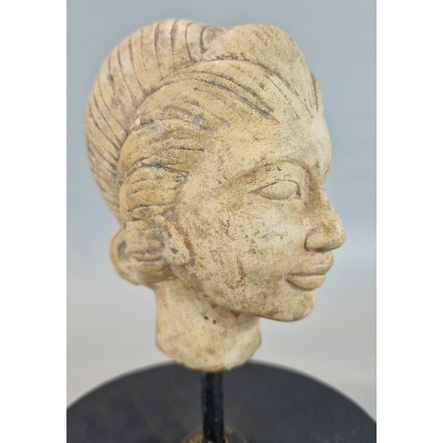 217 - Indonesian/Polynesian hardstone bust of a woman with eyes closed on later stand, the head 11.5cm hig... 