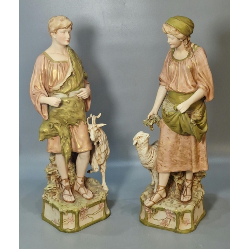 221 - Pair of Royal Dux figures modelled as a Shepherd with a goat by his side and a Shepherdess feeding a... 