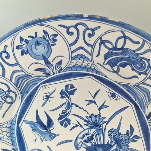 228 - 19th century Delft blue and white hand decorated tin glazed dish, overall decorated with birds among... 