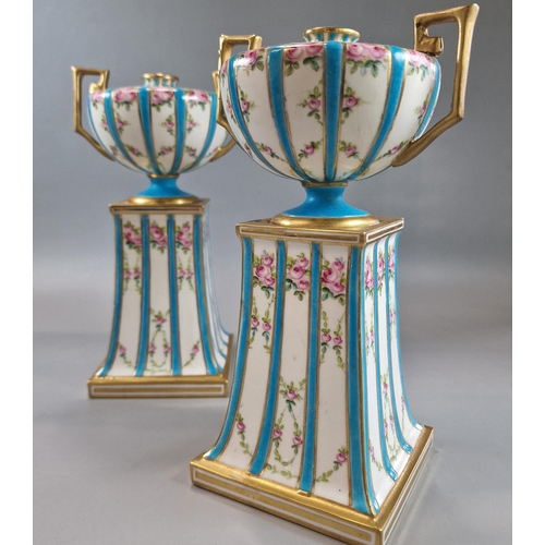 231 - Pair of late 19th century Mintons two handled urn shaped gilded vases on fixed tapering stands, deco... 