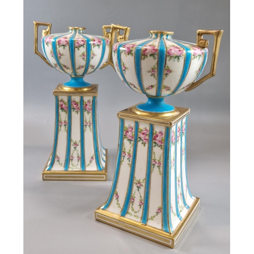 231 - Pair of late 19th century Mintons two handled urn shaped gilded vases on fixed tapering stands, deco... 