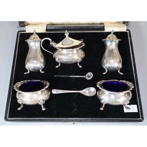 25 - George V silver five piece condiment set in original box to include: pair of boat shaped salts, must... 