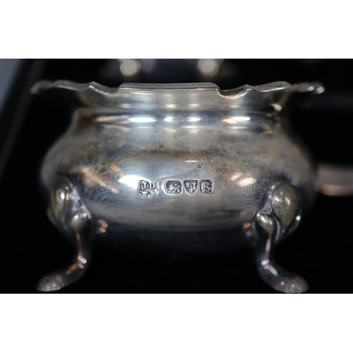 25 - George V silver five piece condiment set in original box to include: pair of boat shaped salts, must... 