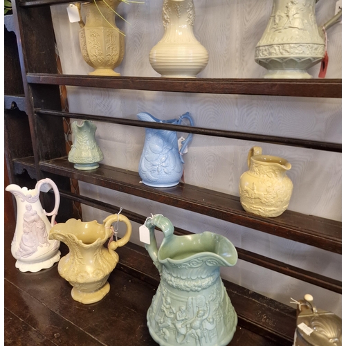 272 - Collection of 19th century pottery jugs and water jugs with pewter lids, all with moulded decoration... 