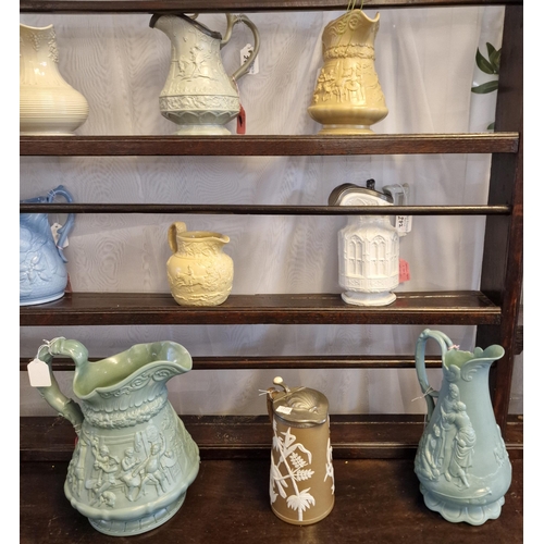 272 - Collection of 19th century pottery jugs and water jugs with pewter lids, all with moulded decoration... 