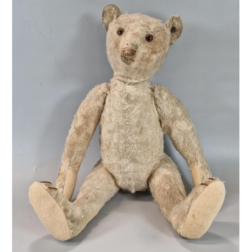 275 - Early 20th century Steiff plush teddy bear, straw filled, with silver button to left ear, having gla... 