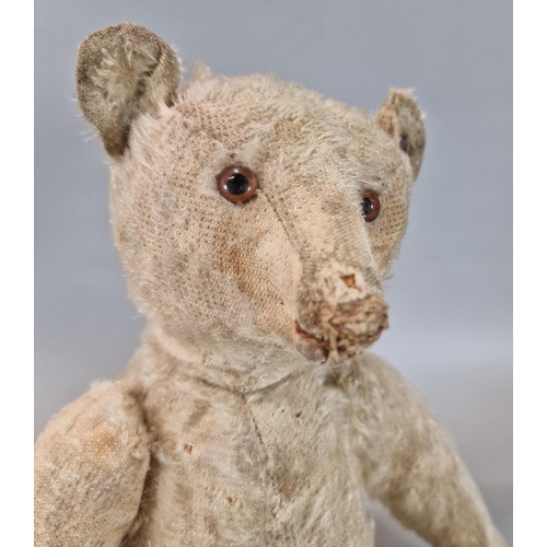 275 - Early 20th century Steiff plush teddy bear, straw filled, with silver button to left ear, having gla... 