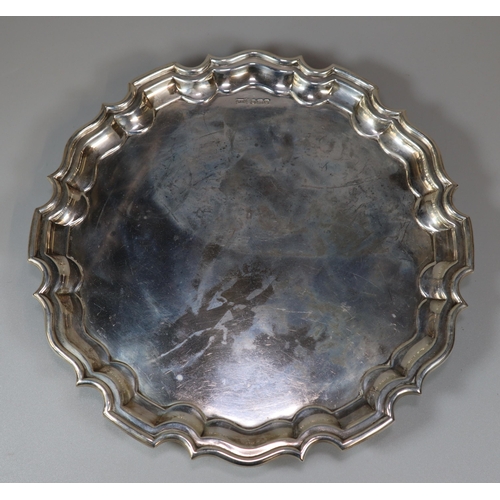 29 - George V silver piecrust salver raised on three scroll feet.  By Walker and Hall, Sheffield 1931. 26... 