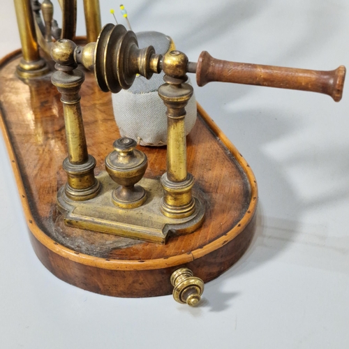 325 - 18th century gilt brass and steel lacemaker's yarn winder on beaded wooden base. (B.P. 21% + VAT)