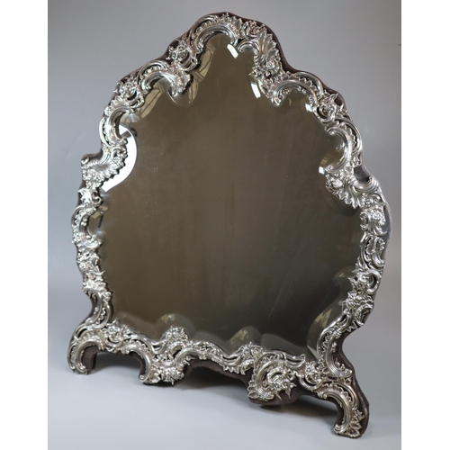 37 - Late Victorian silver easel bevelled bedroom mirror with Rococo and floral designs, by William Comyn... 