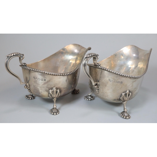 39 - Pair of George V silver gadroon edged sauce boats raised on moulded cabriole legs and paw feet, by T... 