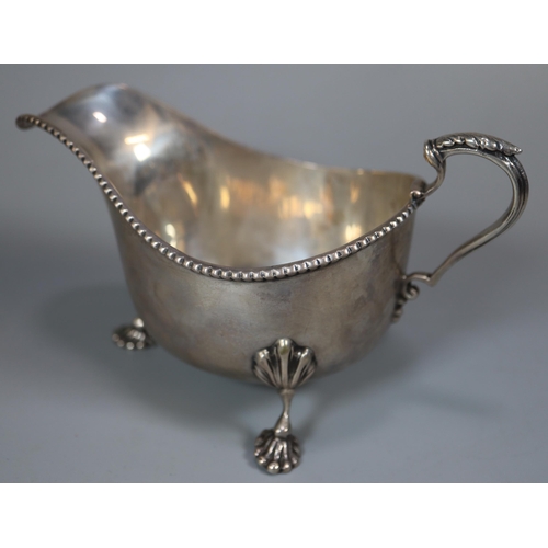 39 - Pair of George V silver gadroon edged sauce boats raised on moulded cabriole legs and paw feet, by T... 