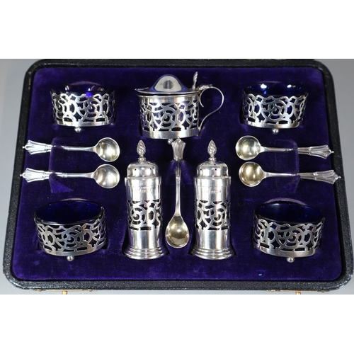 41 - George V silver filigree condiment set comprising: four silver salts, two silver pepperettes, mustar... 