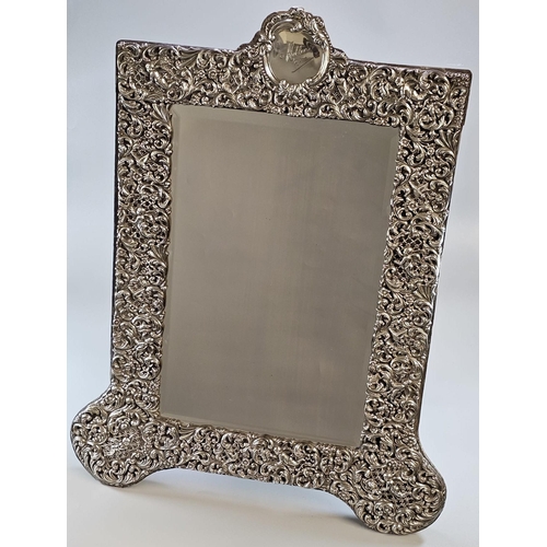 43 - Late Victorian silver easel dressing table mirror, embossed with ornate floral, foliate, cherubs and... 