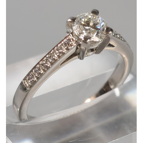 44 - 18ct white gold diamond solitaire ring, each shoulder inset with six tiny diamonds, the central ston... 