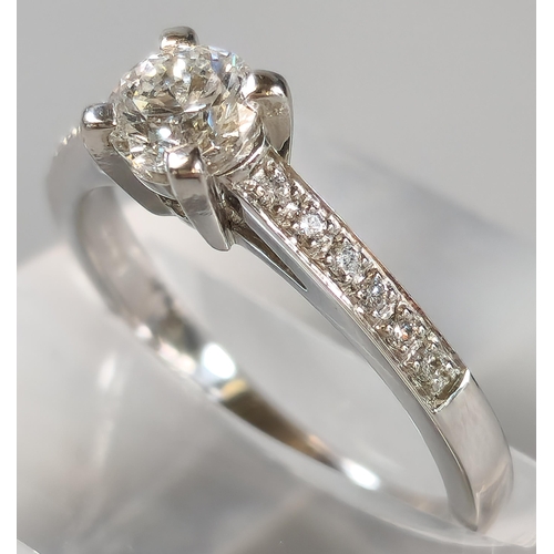 44 - 18ct white gold diamond solitaire ring, each shoulder inset with six tiny diamonds, the central ston... 