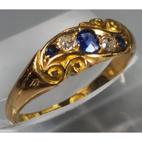 50 - Edwardian 18ct gold diamond and sapphire five stone ring of scroll form. Birmingham hallmarks. 2.6g ... 