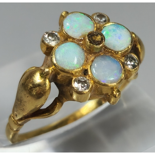 52 - 18ct gold flowerhead ring inset with four diamonds and four opals (missing one diamond). 5g approx. ... 