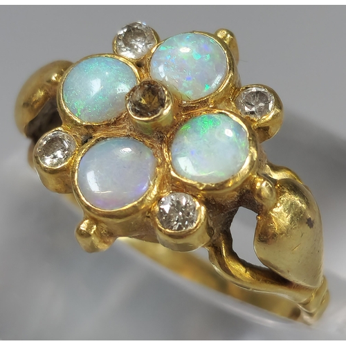 52 - 18ct gold flowerhead ring inset with four diamonds and four opals (missing one diamond). 5g approx. ... 