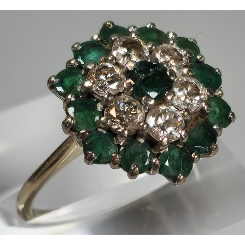 54 - 18ct white gold flowerhead cluster ring inset with thirteen emeralds and six diamonds. 4.8g approx. ... 